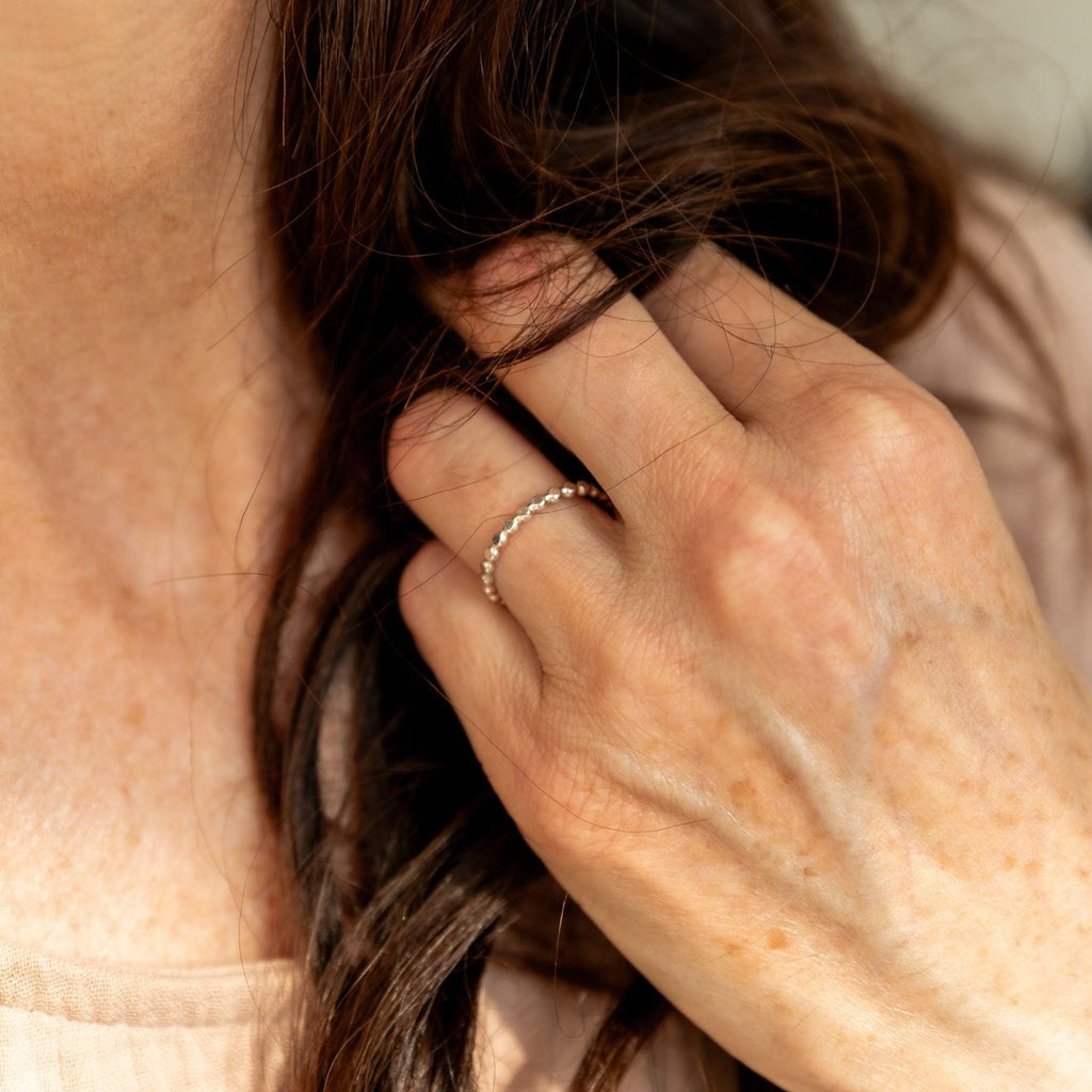 Woman wearing a sterling silver beaded ring