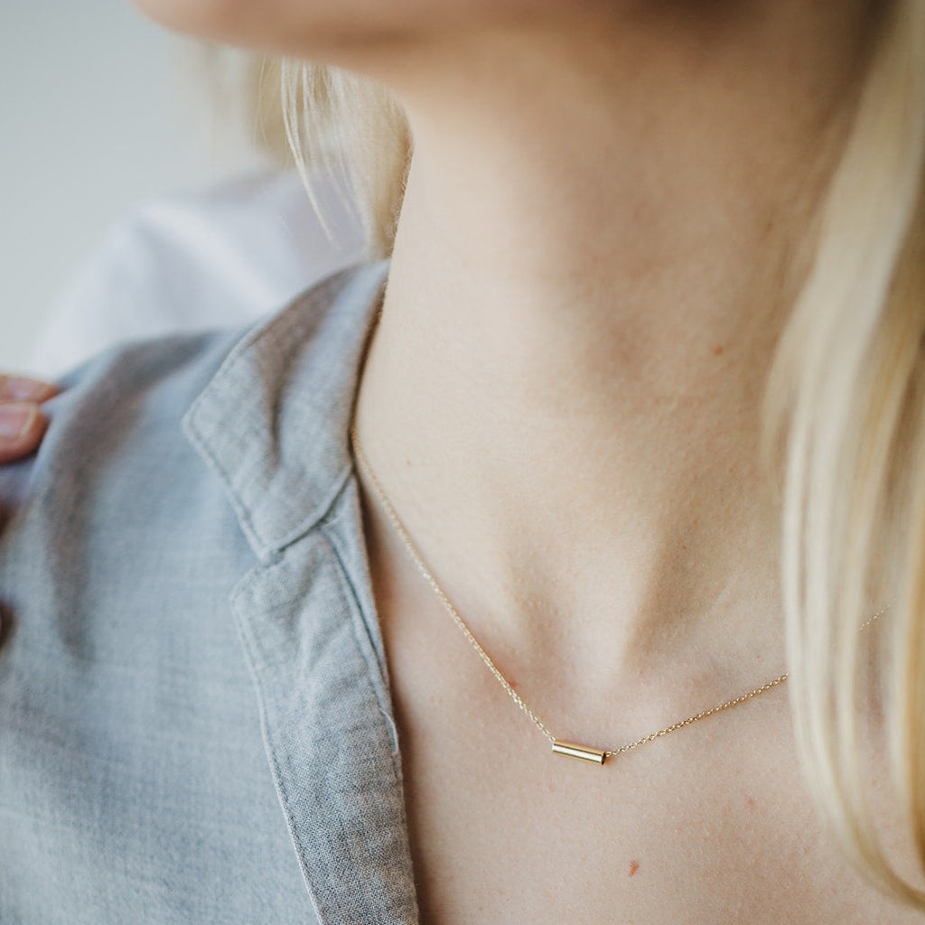 Woman wearing a FRIEDA Jewelry 14k solid gold necklace