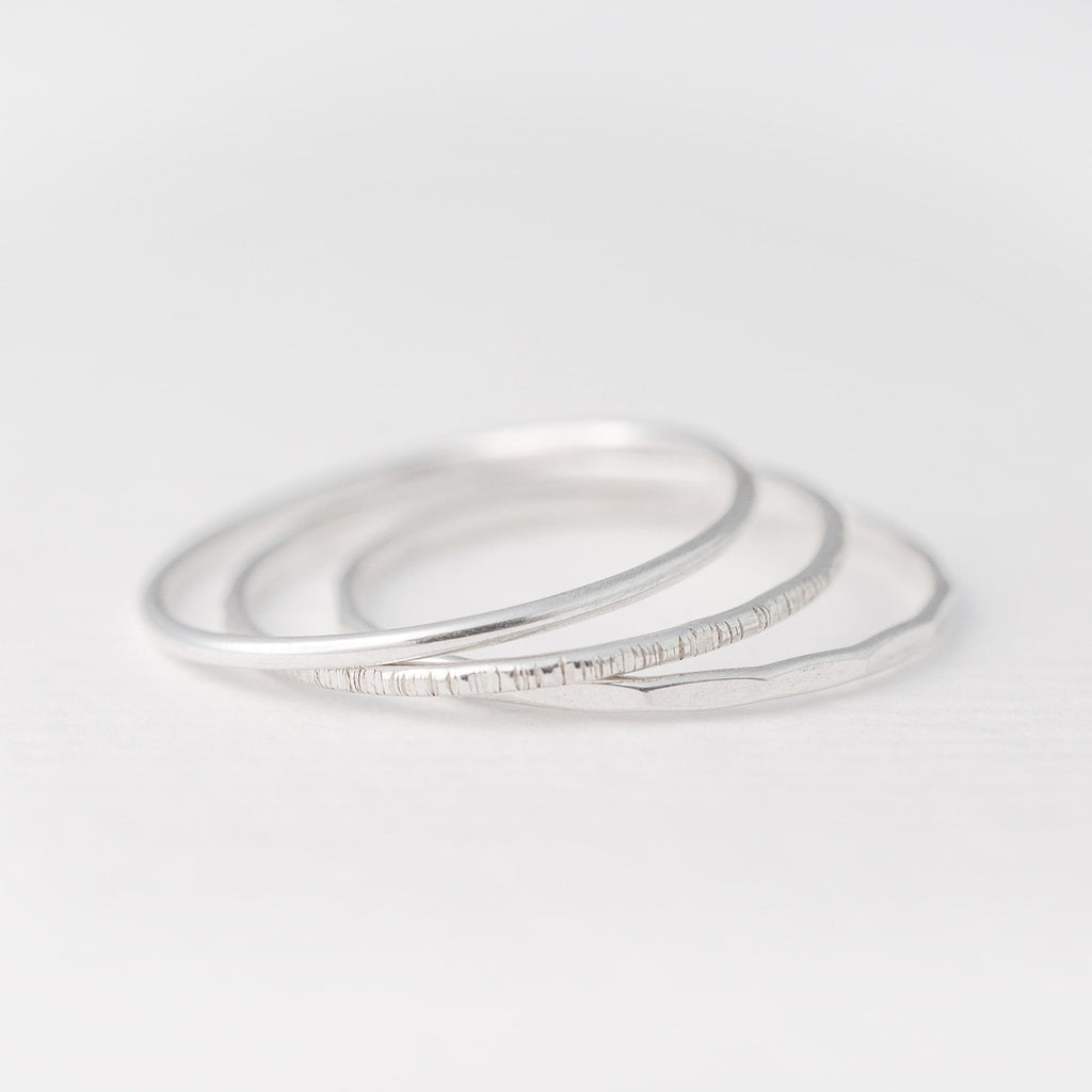 Minimalist handmade sterling silver stacking rings in smooth birch and faceted textures