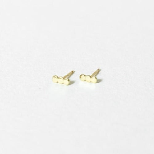 Solid 14k gold stud earrings on a white surface