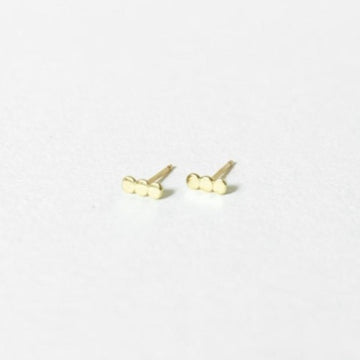 Solid 14k gold stud earrings on a white surface