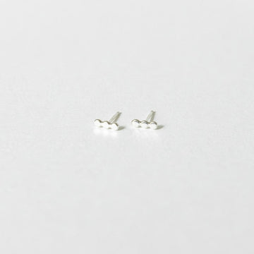 sterling silver stud earrings on a white surface