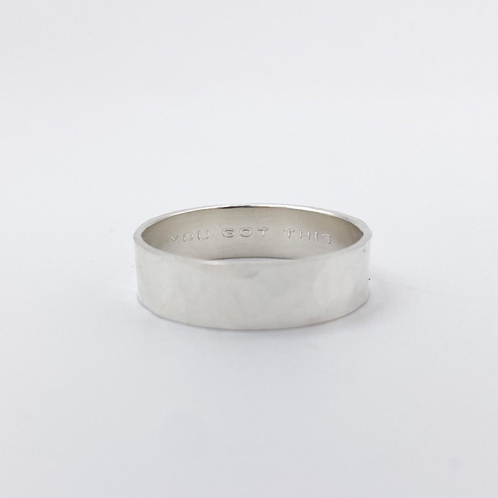 Sterling silver wide band with a hammered texture.  the inside of the band has 'Gou Got This' engraved