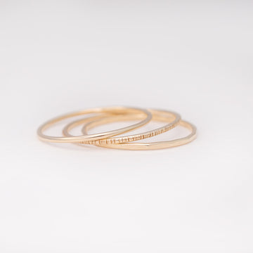 Minimalist handmade 14k solid gold stacking rings with in a smooth birch and faceted texture