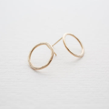 Solid 14K gold water circle earrings with a hammered finish in size medium