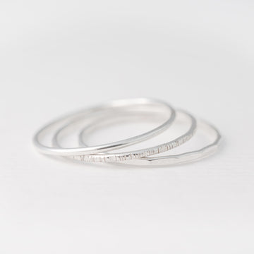 Minimalist handmade sterling silver stacking rings with in a smooth birch and faceted texture