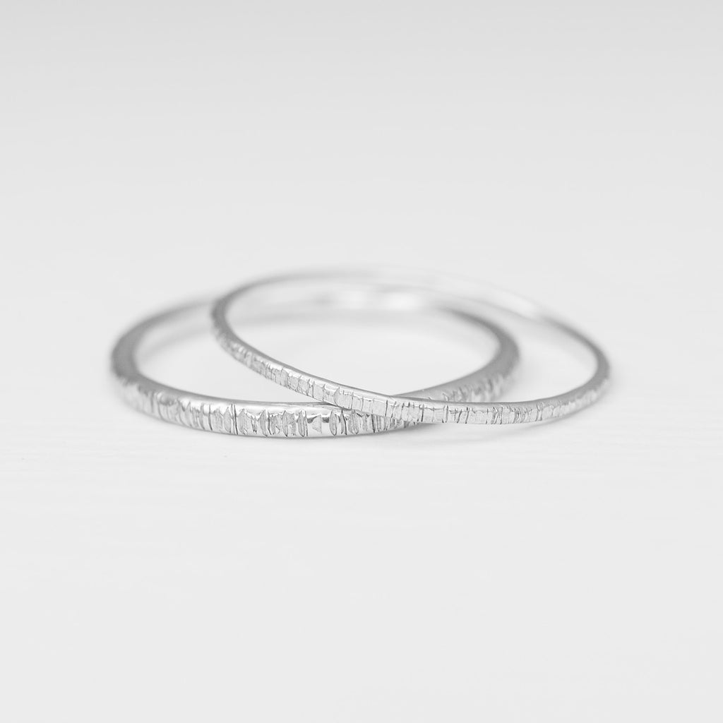 Minimalist handmade sterling silver stacking rings in a  birch texture